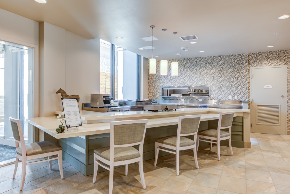A modern kitchen with a spacious counter and seating area.