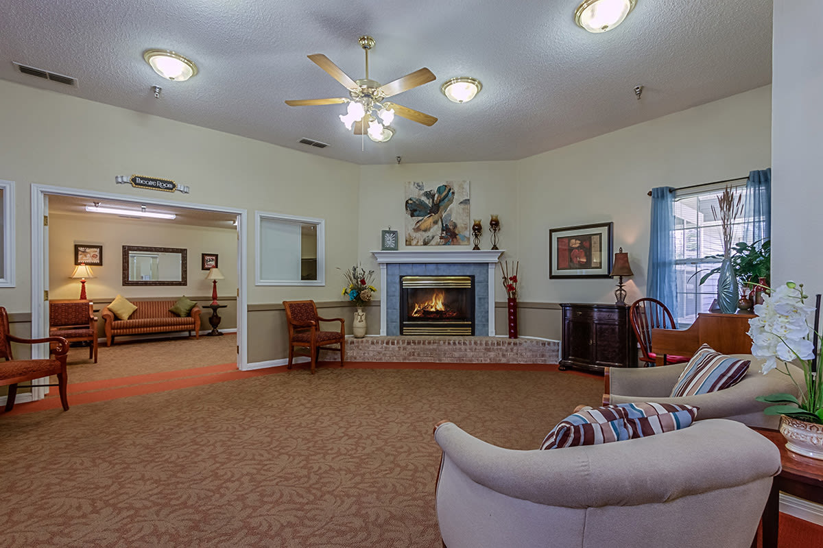 A cozy living room with a fireplace and comfortable seating.