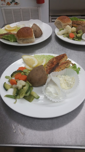 A diverse meal featuring cooked meat, a side of vegetables, and salad.