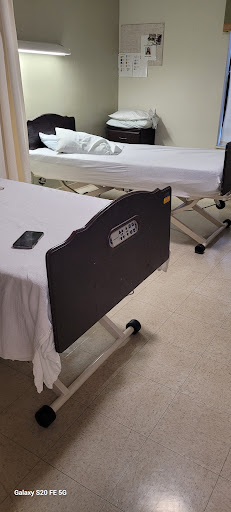 A view of empty hospital beds in a patient room.