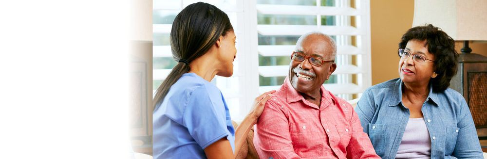 A caring nurse engaging in a warm conversation with an elderly man.