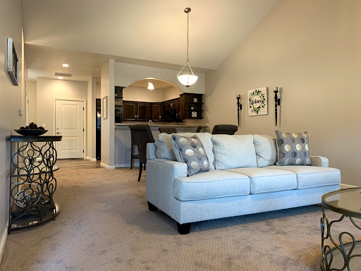 A cozy and modern living room featuring a light-colored sofa and an open layout.