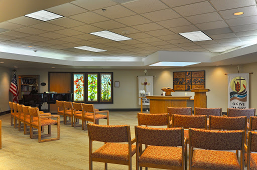 A serene waiting room featuring comfortable seating and ample natural light.