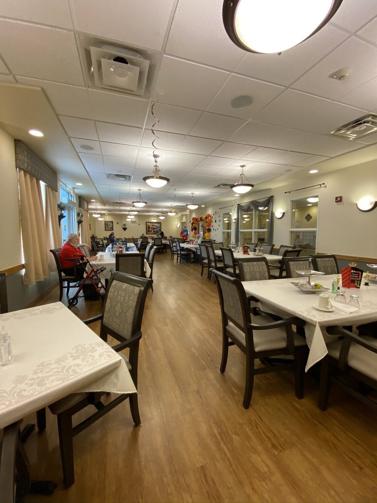 A spacious dining area with neatly arranged tables and chairs in a well-lit environment.