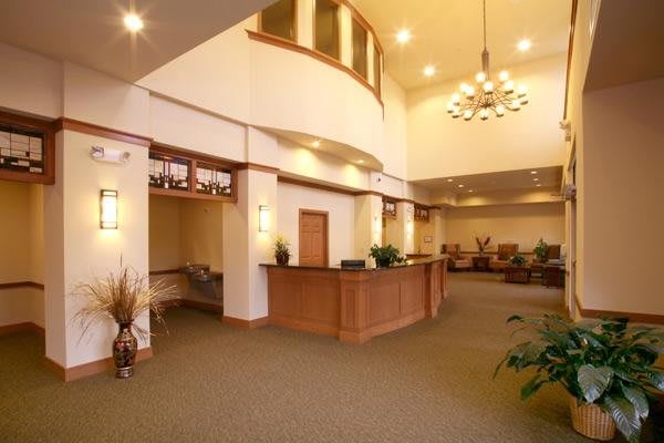 A spacious lobby with a reception desk and comfortable seating.