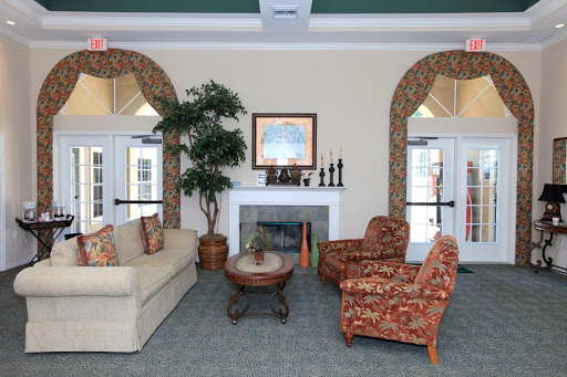 A cozy and inviting lobby area featuring comfortable seating, decorative accents, and a touch of greenery.