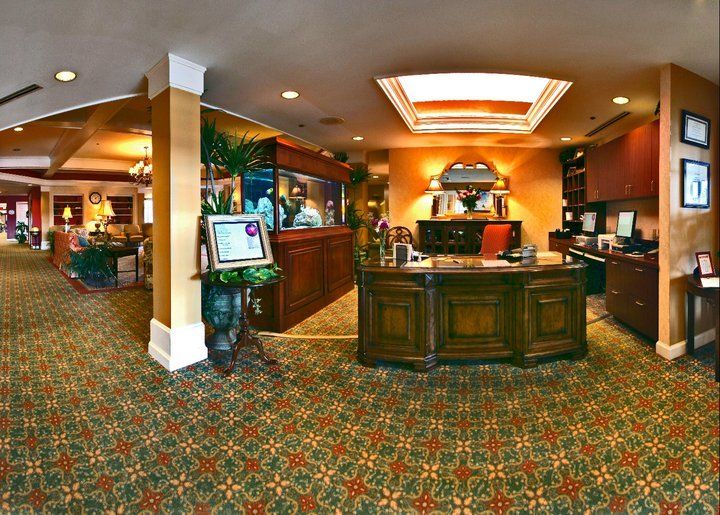 A hotel lobby with a reception desk and cozy interior design.