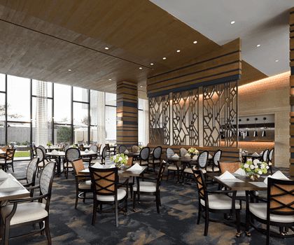 A modern and elegantly designed restaurant interior with neatly arranged tables and chairs.