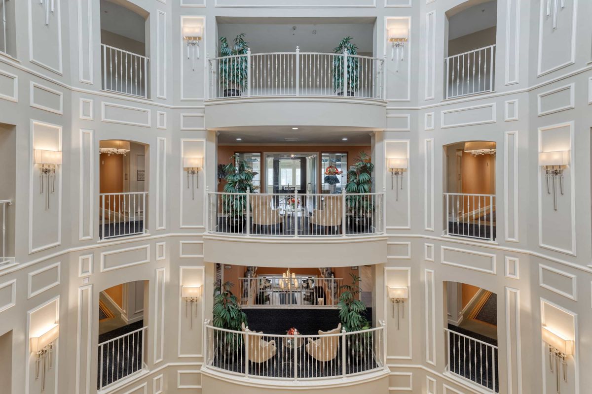 A beautifully designed symmetrical atrium with multiple balconies and elegant architectural details.