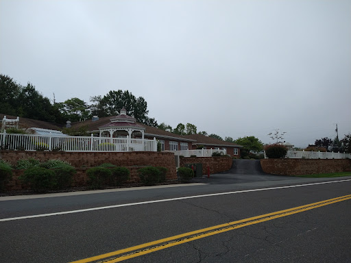 A peaceful residential house shrouded in fog, seen from the road.
