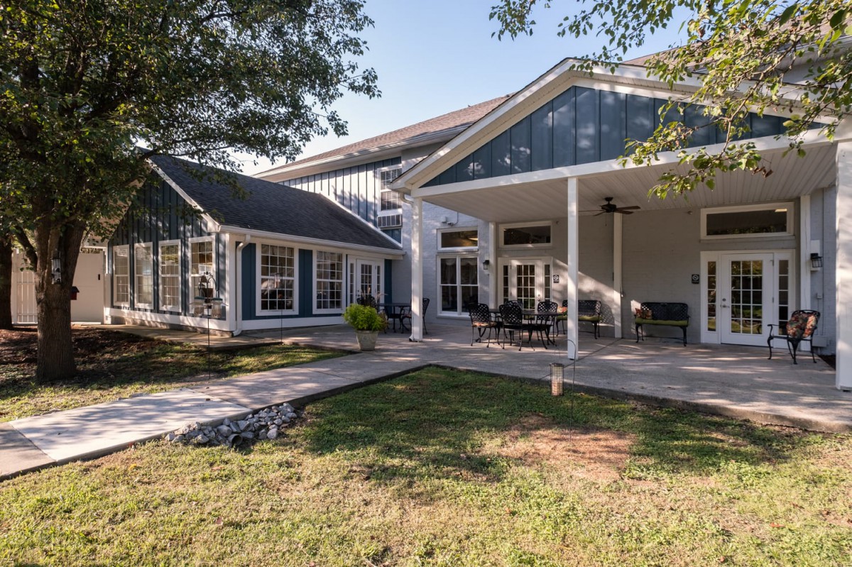 A modern house with a spacious patio and well-maintained yard.
