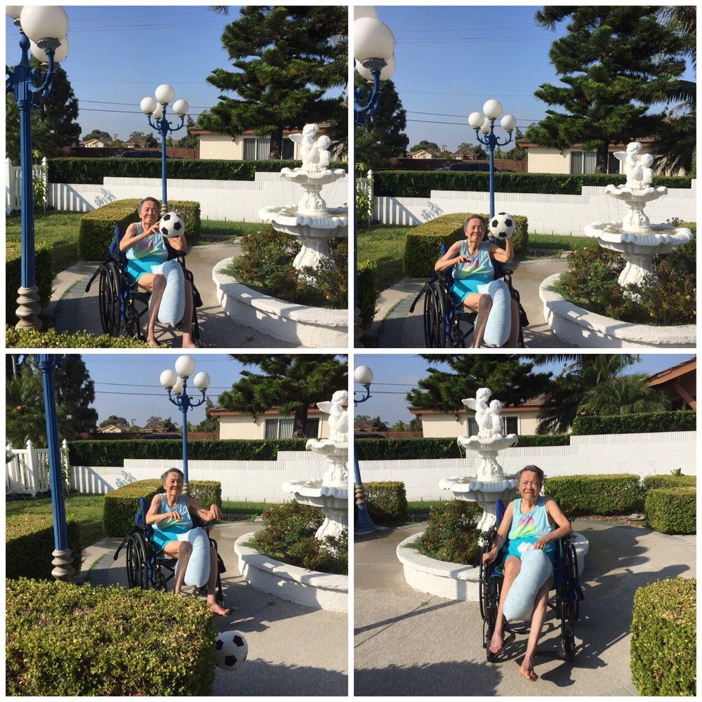 A family enjoying a sunny day by the fountain in the park.