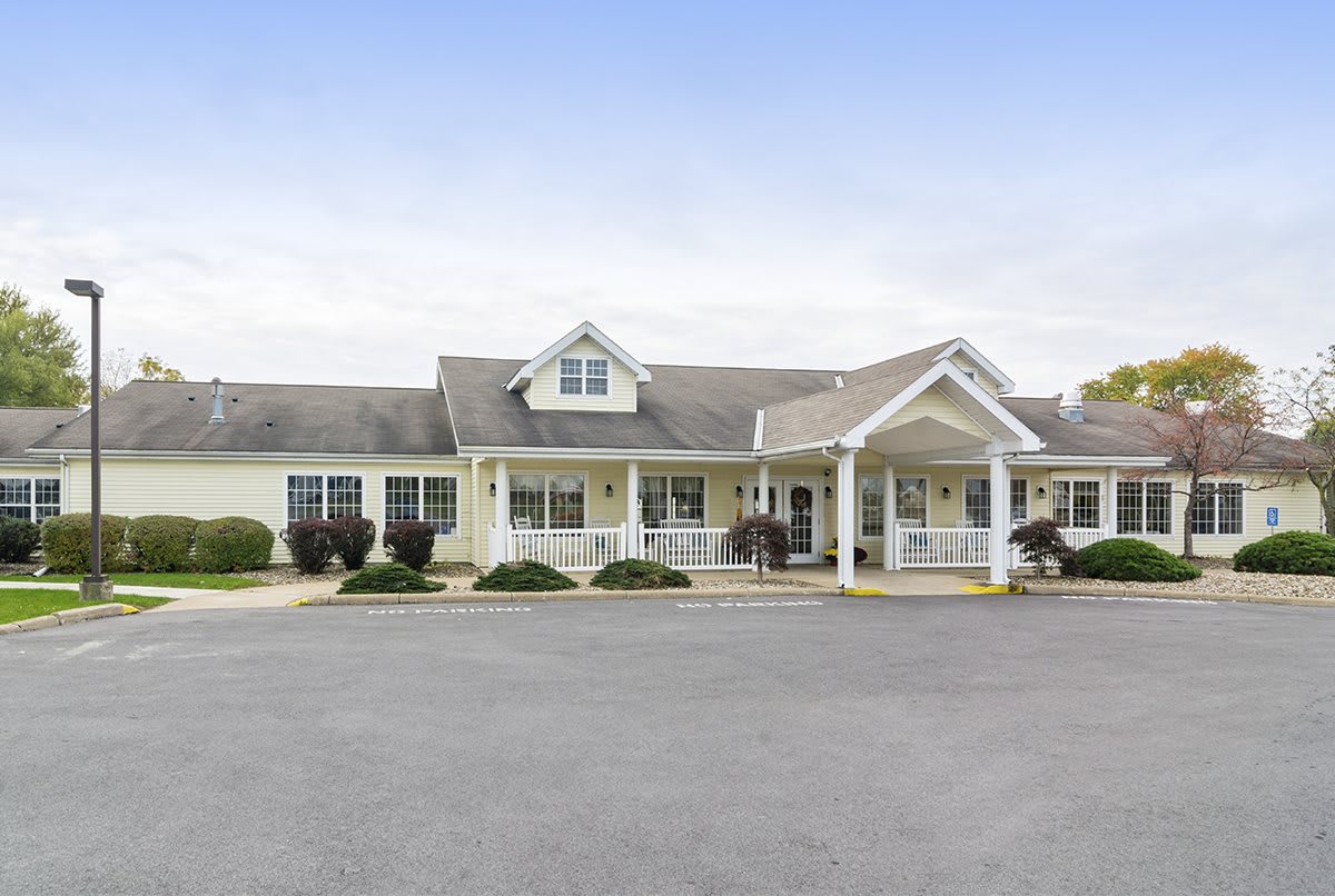 A single-story residential building with a front porch and gable roof.