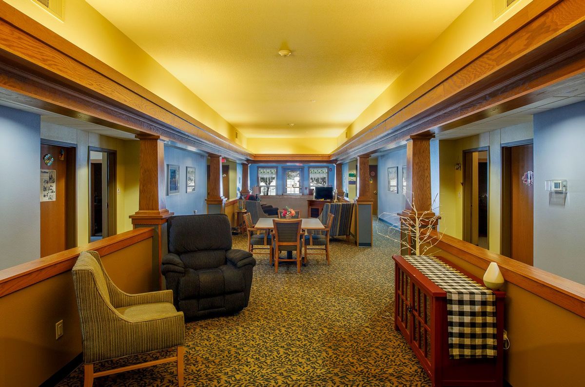 A cozy living room with warm lighting and comfortable seating.