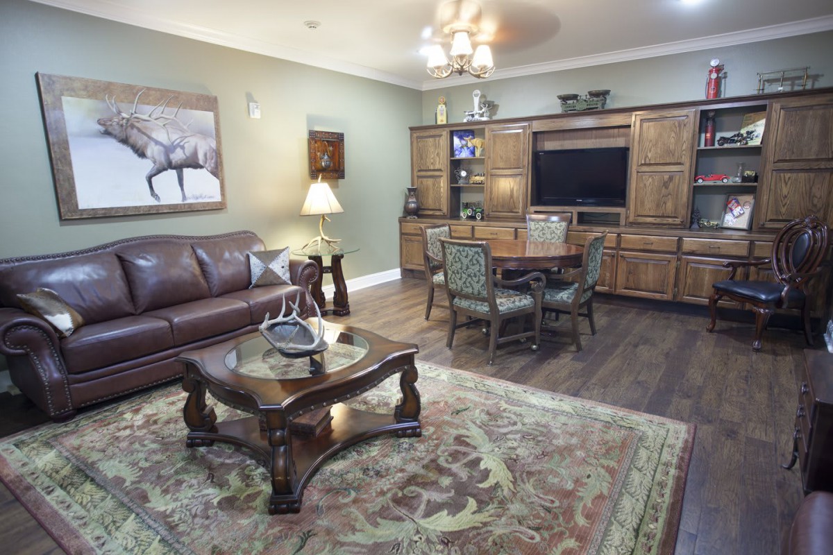 A cozy living room with classic furniture and a large rug.