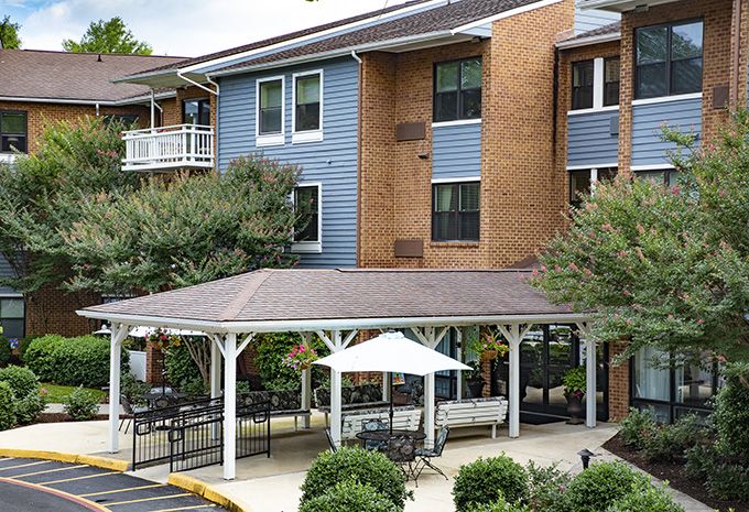 A residential building with a gazebo and surrounding landscaping.