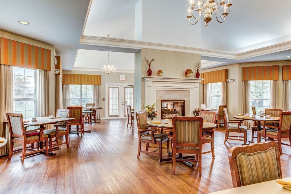 A bright and spacious dining area with a fireplace and elegant furnishings.