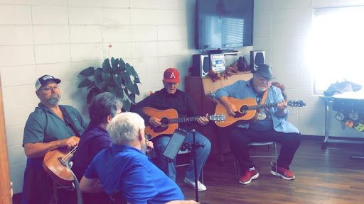 A lively musical gathering with guitarists entertaining an audience.