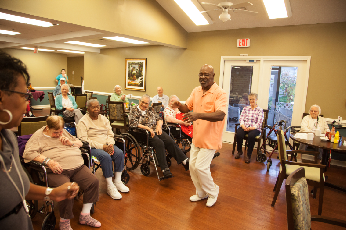 A lively dance session at a community center with senior citizens enjoying the moment.