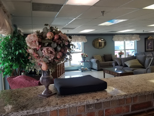 A welcoming lobby area featuring elegant floral arrangements and comfortable seating.