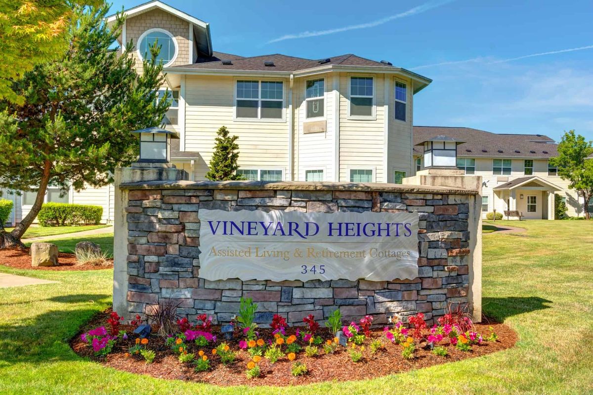 Entrance sign for Vineyard Heights apartment complex with well-maintained landscaping.