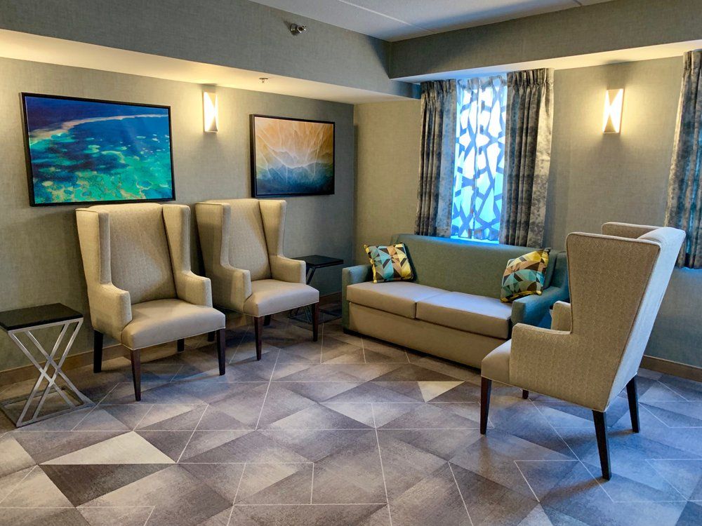 A cozy waiting area with comfortable seating and artwork on the walls.
