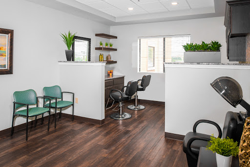 A modern hair salon interior featuring a cozy waiting area and stylish seating.