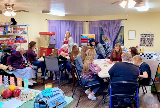 A lively indoor gathering where people are engaged in a creative group activity.