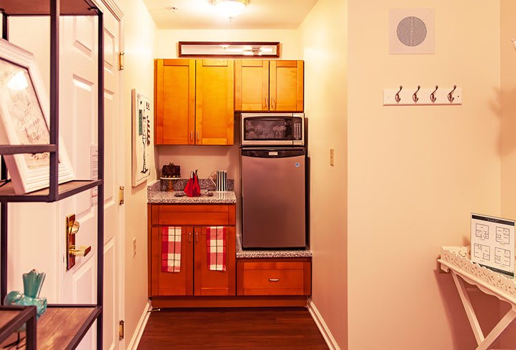 A small, cozy kitchen with wooden cabinets and modern appliances.