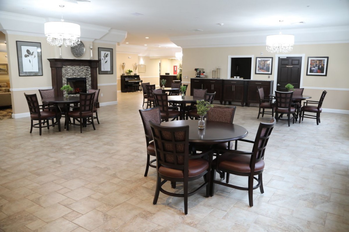 A spacious dining area with multiple tables and chairs arranged neatly.