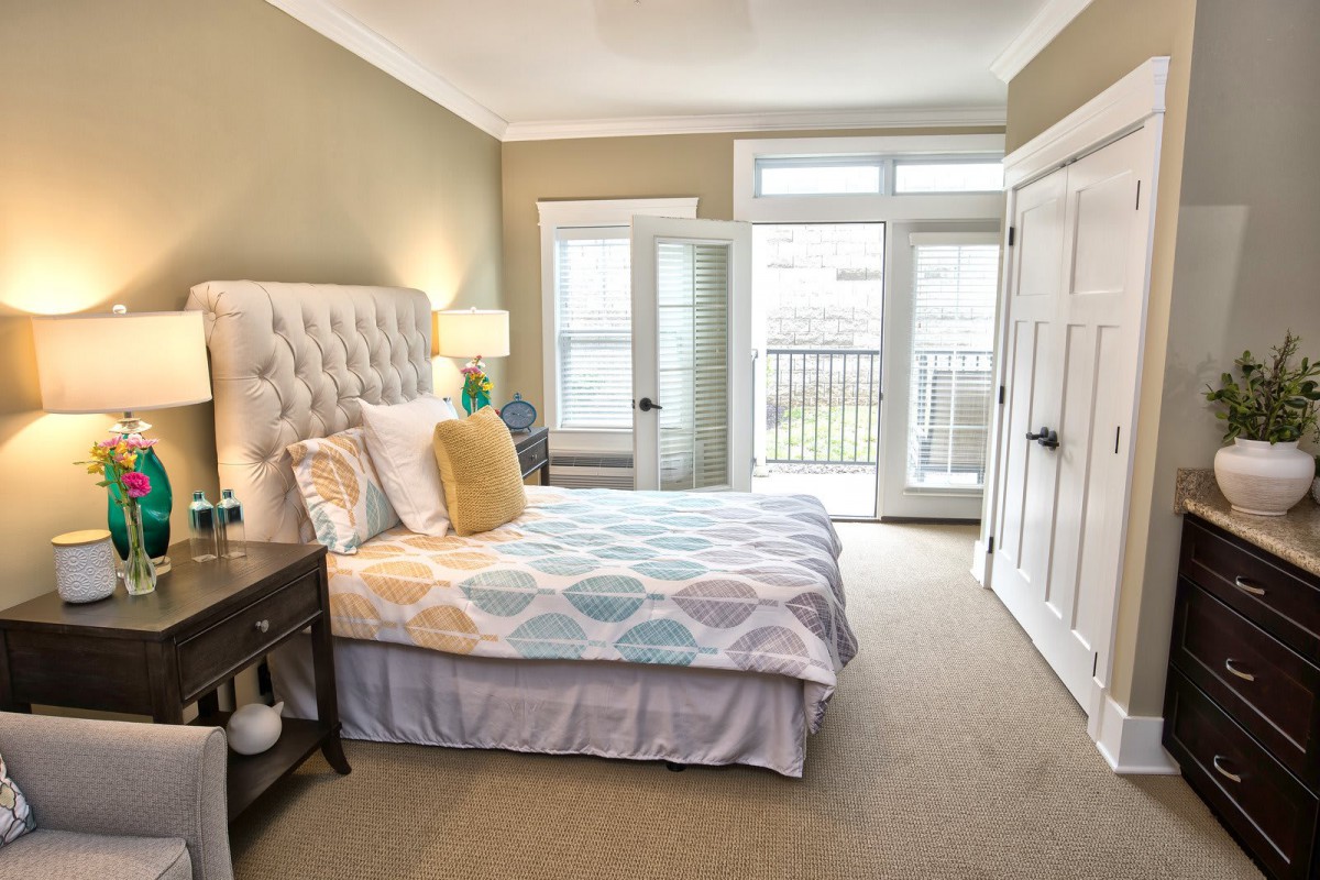 A modern, cozy bedroom with a neatly made bed and stylish decor.