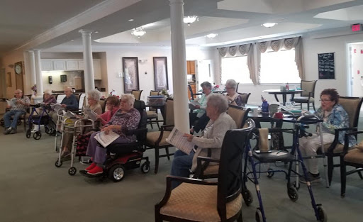 Seniors engaged in an activity at an assisted living facility.