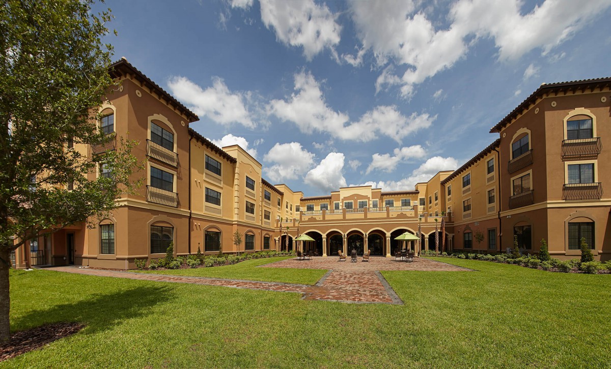 A beautiful building with an open courtyard under a partly cloudy sky.