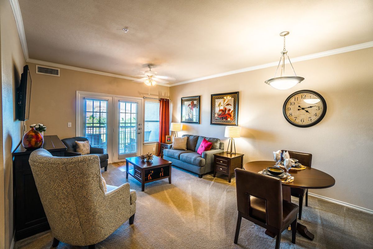 A cozy living room with stylish furniture and warm lighting.