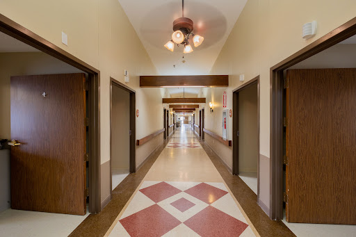 A well-lit hallway featuring multiple doors and decorative lighting.