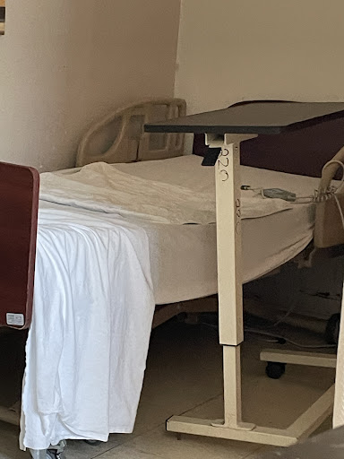 A view of a hospital bed in a patient room, showcasing the essential medical setup.