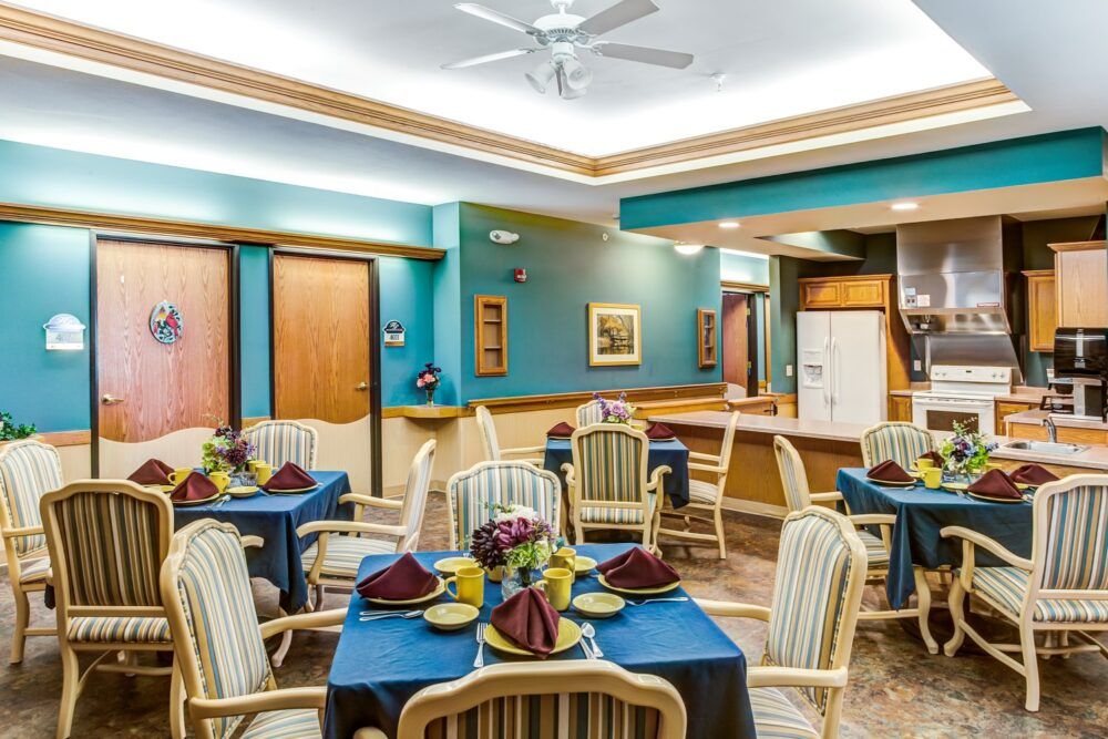 A stylish dining room with neatly arranged tables and chairs, featuring elegant decor and ambient lighting.