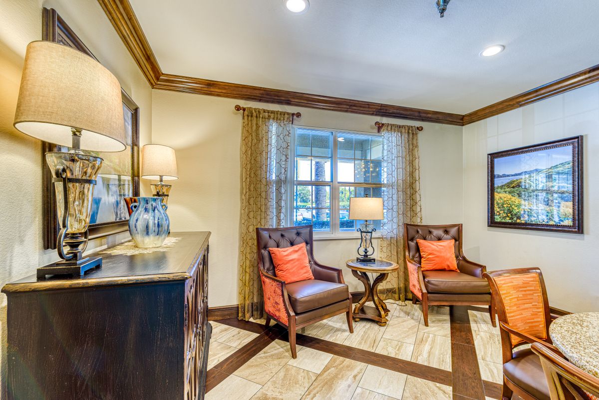 A cozy living room with comfortable chairs and warm lighting.