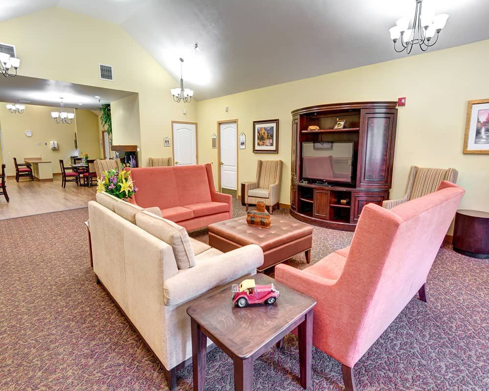 A cozy living room with comfortable seating and a television stand.