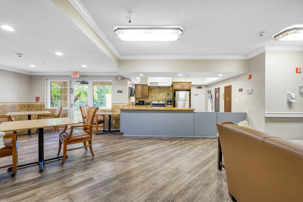 A modern dining and kitchen area with wooden flooring and stylish furniture.