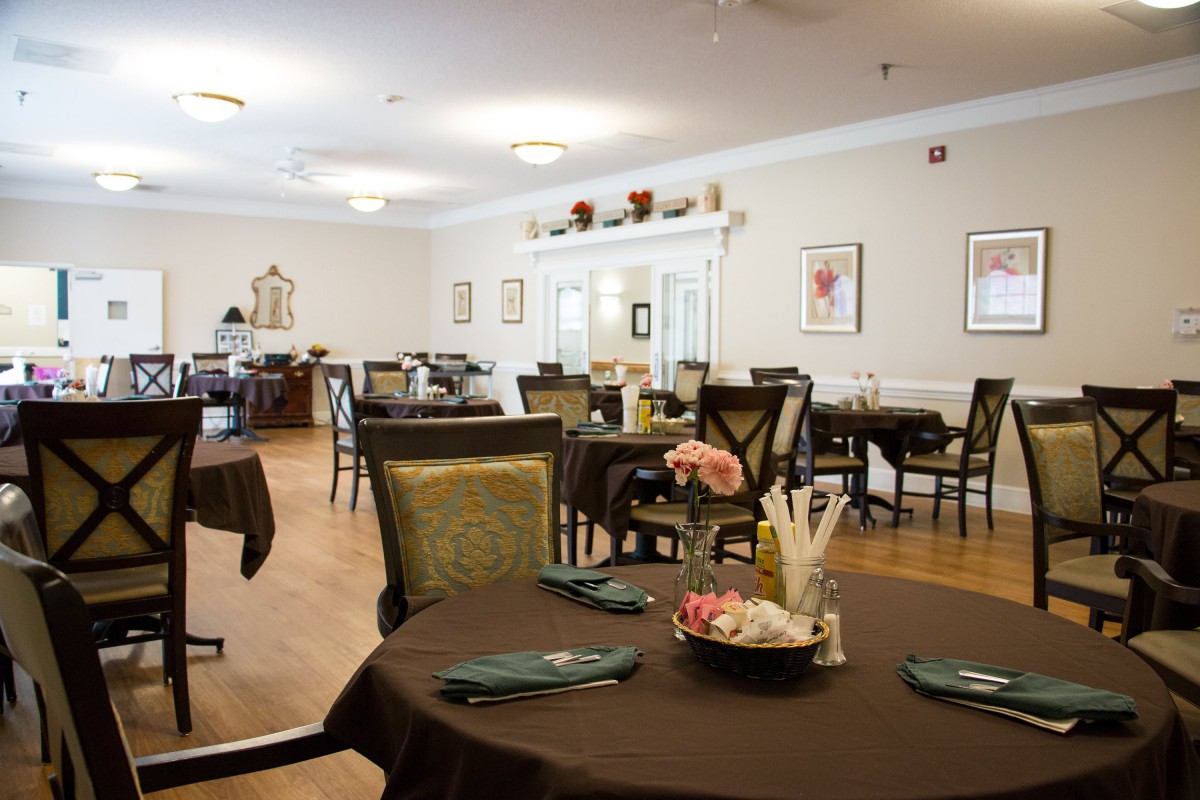An elegant dining room with neatly arranged tables and chairs.