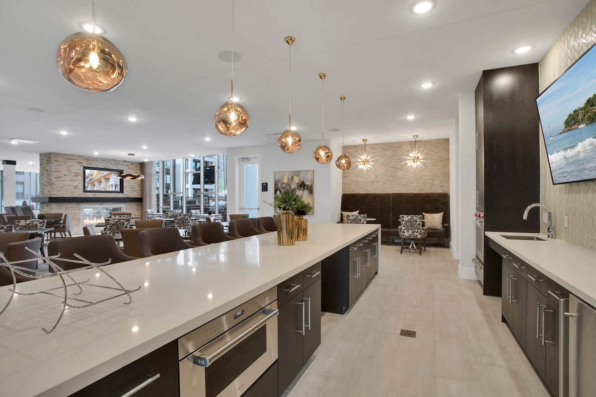 A spacious, modern kitchen featuring an elegant kitchen island, pendant lighting, and open concept design.