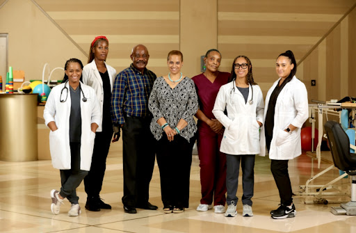 A diverse group of medical professionals posing together, showcasing collaboration in healthcare.