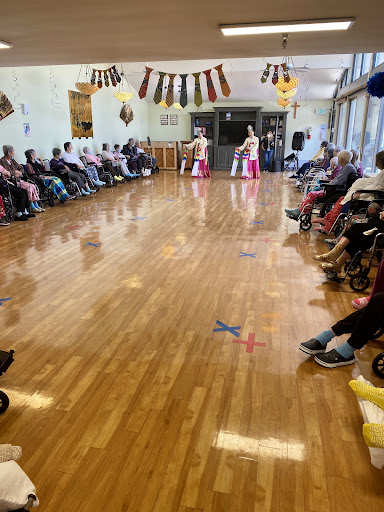 A joyful performance entertaining seniors in a community center.
