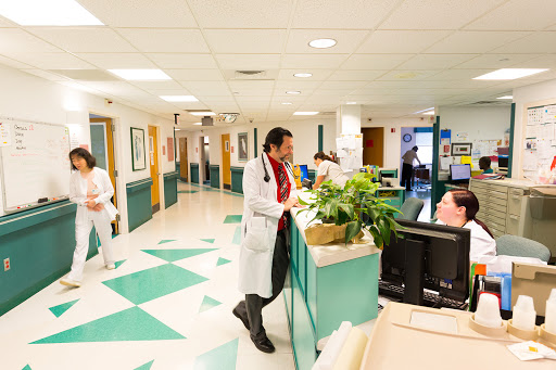 A busy hospital corridor with medical staff attending to patients.