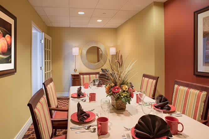 Elegant dining room with a beautifully set table and a decorative centerpiece.