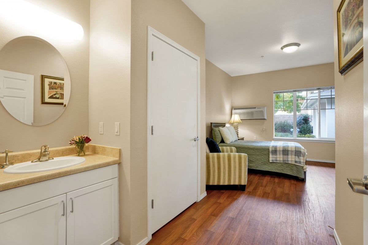 A well-furnished bedroom with modern decor, featuring a comfortable bed and stylish seating.