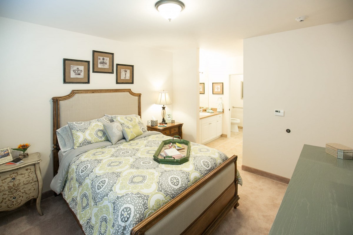 A cozy bedroom with a comfortable bed, elegant decor, and soft lighting.