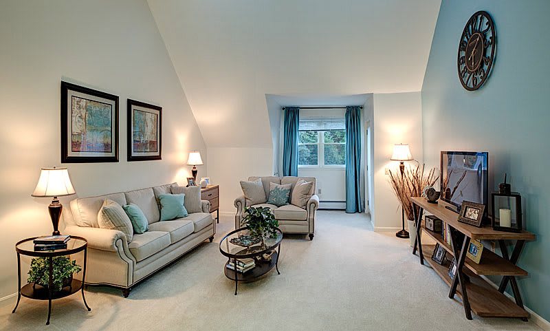 A cozy living room with neutral-toned furniture and soft lighting.