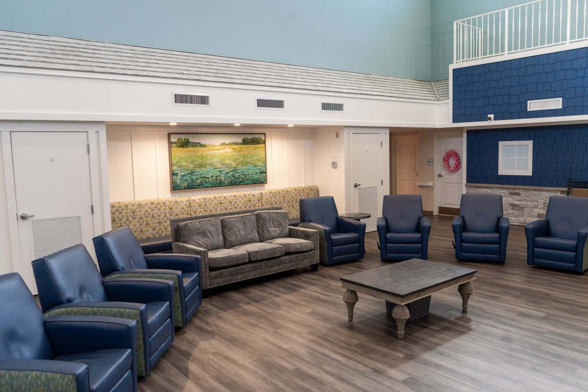 A modern and cozy living room with comfortable seating and a central table.